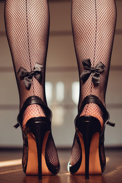 sexy woman legs in high heel sandals. fishnet stockings with black bow.  Stock 写真 | Adobe Stock