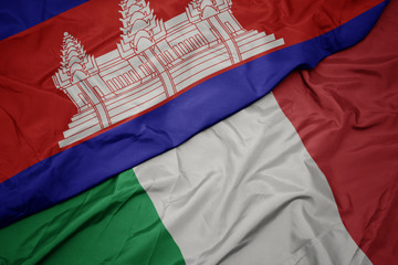 waving colorful flag of italy and national flag of cambodia