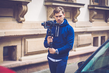 Handsome Influencer Vlogger Make Video with Mirrorless Camera and Gimbal in The City