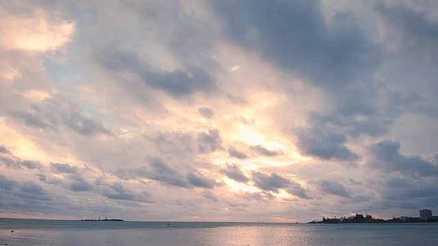 Time lapse video of an amazing Sunset with moving clouds in an explosion of color at Anse Vata Bay in Noumea, New Caledonia, French Polynesia, South Pacific.