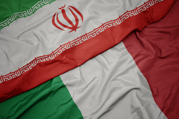 waving colorful flag of italy and national flag of iran.