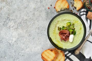 Broccoli cream soup on a concrete background. View from above.