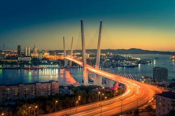 Cityscape overlooking the Golden bridge in blue hour. Bright illumination adorns the night city.