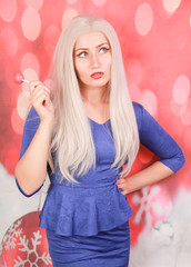 pretty blonde woman in blue peplum dress on red xmas background