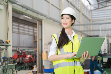 Asian woman working in factory.