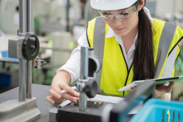 Asian woman working in factory.