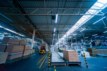 Fototapeta premium Production line of the wooden floor factory. CNC automatic woodworking machine.