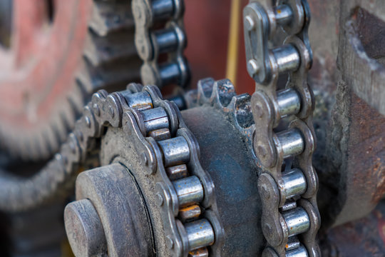 The system of chain and gears of an agricultural machine, close-up.