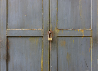 Close up key locked at metal door.