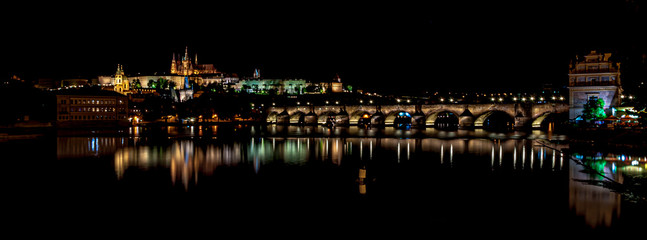 Beautiful night view of Hradcany. Classic panoramic view of Charles Bridge and Prague castle over Vltava river. Prague, Czech Republic