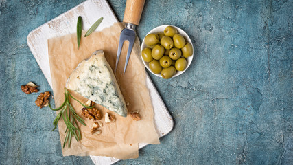 Soft blue cheese with rosemary, nuts and green olives