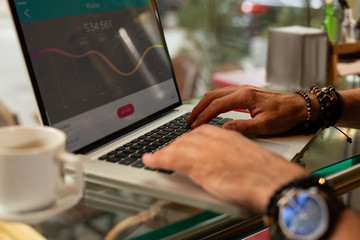 Man calculating the expenses on his laptop.