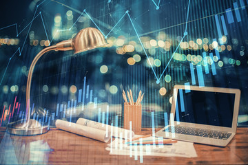 Financial graph colorful drawing and table with computer on background. Multi exposure. Concept of international markets.