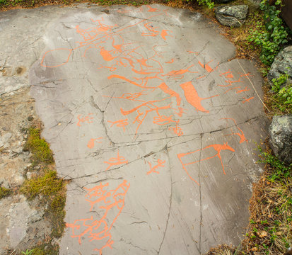 Rock art in Alta Fjord, Norway. Ancient symbols, real drawing,  texture in stone. Red ocher paint. Human preys on animals deer.  Group of petroglyphs, dating from c. 4200 to 500 B.C.