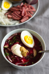 cold summer soup with beets and place for textan against gray background
