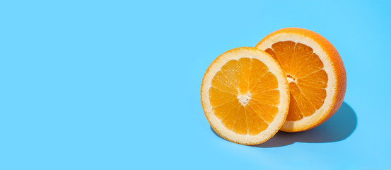 Ripe juicy delicious orange on blue background. Healthy eating and dieting concept. Copy space. Free space for your text