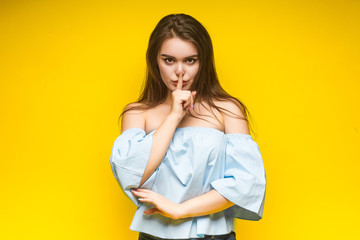 Portrait of cheerful lady showing promotion ads wearing denim jeans touch her cheeks with hands screaming isolated over teal yellow background. Lifestyle.