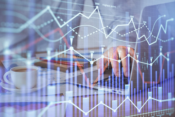 Forex graph with businessman working on computer in office on background. Concept of hardworking. Multi exposure.