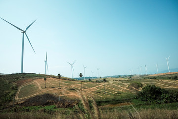Wind turbines on hill with clear sky