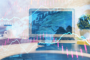 Financial market graph hologram and personal computer on background. Multi exposure. Concept of forex.