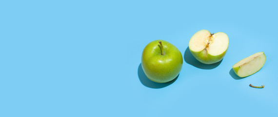 Ripe parts green apple Isolated on a blue background. Healthy eating and dieting concept. Copy space. Free space for your text