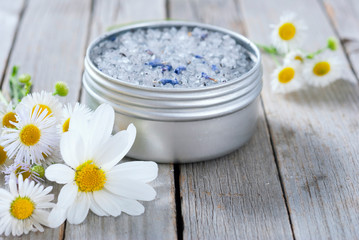 blue bath salt in tin pot on natural old wood table texture