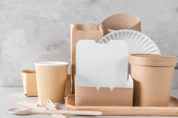 Fototapeta na wymiar Eco friendly disposable tableware. Paper cups, dishes, fast food containers and bamboo wooden cutlery.