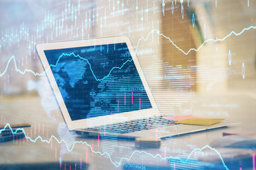 Stock market graph and table with computer background. Double exposure. Concept of financial analysis.