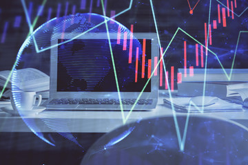 Financial market graph hologram and personal computer on background. Multi exposure. Concept of...