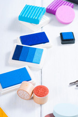 ink pads, brushes and carving cutters on white wood table