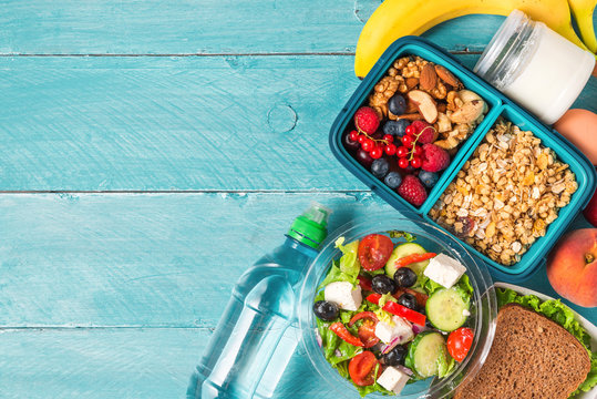 Set Of Lunch Boxes With Food Ready To Go For Work Or School. Greek Salad, Sandwich, Vegetables, Granola, Nuts, Berries