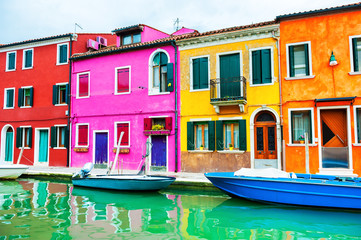 Fototapeta na wymiar Colorful houses on the canal in Burano island, Venice, Italy. Famous travel destination