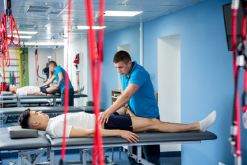 Rehabilitation therapy. Physiotherapist working with young male patient in the rehabilitation center