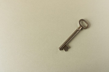Old key on grey background. Key isolated on grey background.