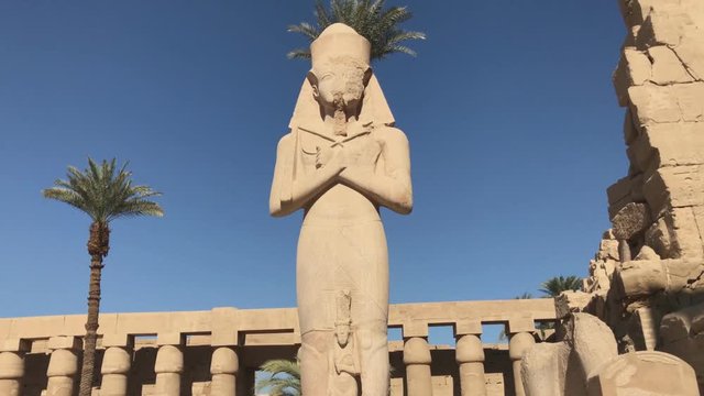 Ramses II enormous stone statue in peristyle courtyard in the Temple of Amun-Ra at Karnak Antique Thebes Luxor, Egypt.