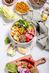 Quinoa salad with chickpeas, spinach, tomatoes, healthy vegan food, diet and clean eating concept,...