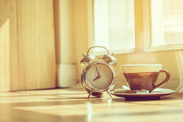 Coffee morning and alarm clock close up  in the morning sunlight,Good morning