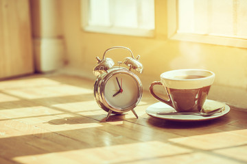 Coffee morning and alarm clock close up  in the morning sunlight,Good morning