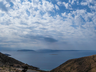 A steep and dangerous road down leading to Stara Baska Beach. Thick clouds above. Beautiful coastal line of Croatia. Beach is surrounded with tall hills from each side. Hidden gem of Croatia.