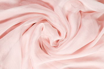 Fototapeta na wymiar Soft smooth pink silk fabric background. Fabric texture.