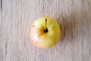 close up red apple isolated on wood background