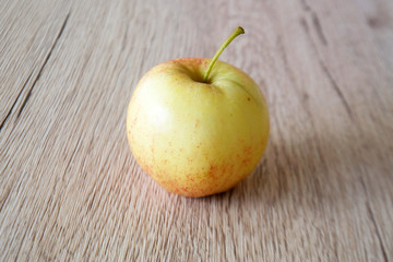 close up red apple isolated on wood background
