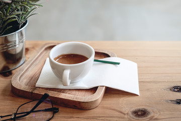 Coffee cup  on old wooden kitchen table, copyspace for your text.