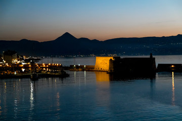 View of the fortress and ships in the port of Heraklion at sunset