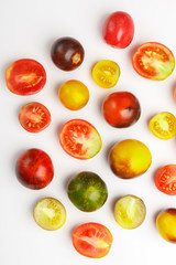 Background made from different tomatoes, white background