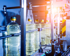 Bottling line of sunflower oil in bottles. Vegetable oil production plant. High technology.