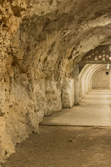 Part of the small underground tunnel with the stone wall - Image