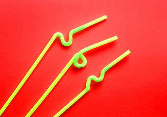 Yellow plastic cocktail tubes with a flexible part, due to which they can be twisted into a knot or...