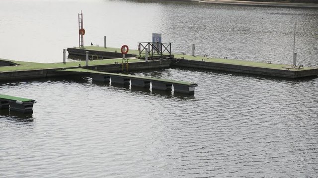 Wooden pier for boats on the river bank.