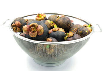 group of mangosteen fruit in the stainless steel basket